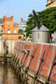 Antique crane & Hamburger Elbinsel Tower beside Zoll canal. Hamburg, Germany