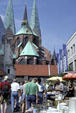 Marienkirche looms over antique market. Lübeck, Germany.