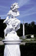 Classical-style sculpture of greek helmeted god with dog in Sanssouci garden. Potsdam, Germany.