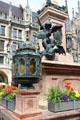 Lantern & St Michael slaying Dragon on base of Marien column at Neues Rathaus. Munich, Germany.