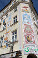 Building painted with beer brands at Viktualienmarkt. Munich, Germany