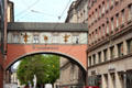 Arched bridge over Maffeistraße between two commercial buildings. Munich, Germany
