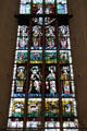 Modern stained glass window features lesser-known bishop saints at Frauenkirche. Munich, Germany.
