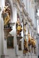 Sculpted saints along nave at Peterskirche. Munich, Germany.