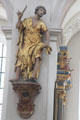 Statue of St Bartholomew with symbolic knife & flayed skin at Peterskirche. Munich, Germany.