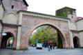 Sendling Tor restored brick gate with 2 hexagonal towers, opening onto an Old Town plaza with a fountain. Munich, Germany