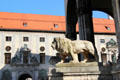 Lion sculpture at Feldherrnhalle with Munich Residenz beyond. Munich, Germany.