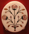 Mother of pearl inlaid marble plate with floral design from Agra, India at Five Continents Museum. Munich, Germany.