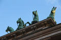 Four horses of quadriga of Victory atop Brandenburg Gate. Berlin, Germany.