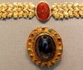 Gold plating oval brooch with sapphire from Southern Russia under cameo bracelet at Altes Museum. Berlin, Germany.