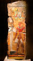 Egyptian painted stone relief of king Seti I in front of god Osiris from Thebes West at Neues Museum. Berlin, Germany.
