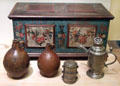 Rustic chest with floral painting from Saxony or Thüringen; 2 Bartmanns stoneware jugs from Rhineland; stacked pewter food boxes ; & pewter screw top jug for harvest festival 1793 from Thüringen at German Historical Museum. Berlin, Germany.
