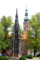 Heinrich Rubenow monument with St. Nicholas Church tower. Greifswald, Germany.