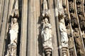 Carved figures beside south entrance doors to Köln Cathedral. Köln, Germany.