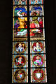 Stained glass windows depicting a stoning scene & various saints in Köln Cathedral. Köln, Germany.