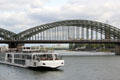 Tour boat passing under Hohenzollern rail bridge. Köln, Germany