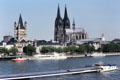 Skyline from Deutzer Bridge over Rhine with towers of Gross St Martin church & Cologne Cathedral. Köln, Germany