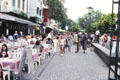 Outdoor restaurants & people strolling along Fischmarkt. Köln, Germany.