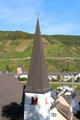 Church spire with view of Mosel River, Catholic Church of Sts. Peter & Paul & vineyards on opposite bank. Zell, Germany.