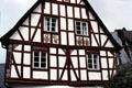 Top floors of half-timbered house with family crests on facade. Pünderich, Germany.