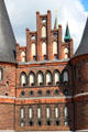 Red & black brickwork around smaller defensive windows of Holsten Gate. Lübeck, Germany.