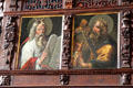 Paintings of Moses with horns holds tables & King David play harp on organ loft at St. Jacob's Church. Lübeck, Germany.