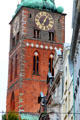 Brick clock tower of St. Jacob's Church with quoins & Gothic arches. Lübeck, Germany.