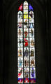 Modern stained glass window of nobles facing skeletons of death at St. Mary's Church. Lübeck, Germany.