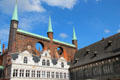 Brick Gothic shield wall above Renaissance arcade with Long House at right at Lübeck Rathaus. Lübeck, Germany.