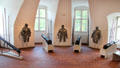 Suits of armor & canons in round Butcher's Tower at Gottorf Palace. Schleswig, Germany.