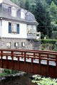 Footbridge over Rur River with Germanic house in background. Monschau, Germany.