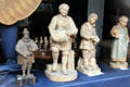 Statues representing wine production activities in shop window. Bacharach, Germany.