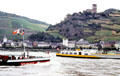 Busy Rhine River traffic with Gutenfels Castle in background. Kaub, Germany.