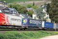 Container train traveling along west bank of Rhine. Oberwesel, Germany.