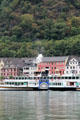 Sightseeing boat with St. Goar in the background. St. Goar, Germany.