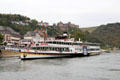 Sightseeing boat with Rheinfels Castle in the distance. St. Goar, Germany.