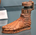 Greek terracotta vessel in shape of sandaled foot from Rhodes at Antikensammlungen. Munich, Germany.