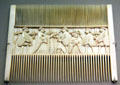 Ivory double comb with carving of wisdom of Salomon from Italy at Bavarian National Museum. Munich, Germany.