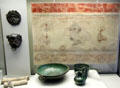 Roman-era wall painting from Kempten plus bronze masks & vessels plus white sections of lead pipe at Bavarian State Archaeological Collection. Munich, Germany.