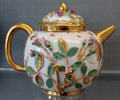 Meissen porcelain teapot with applied rose branches painted in gold & enamel colors at Meissen porcelain museum at Lustheim Palace. Munich, Germany