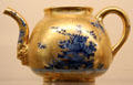 Meissen porcelain gold teapot painted with blue flowers at Meissen porcelain museum at Lustheim Palace. Munich, Germany.