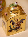 Meissen porcelain tea caddy with gold background, tree flowers & insects at Meissen porcelain museum at Lustheim Palace. Munich, Germany