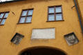 Plaque & coats-of-arms over entrance at Fuggerei commemorating Jakob Fugger & his deceased brothers. Augsburg, Germany.