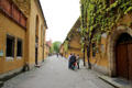 Street & ivy covered homes within walls of Fuggerei. Augsburg, Germany.