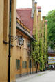 Ivy covered homes with steeply gabled roofs within walls of Fuggerei. Augsburg, Germany.