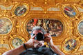 Photographer's reflection with ceiling via rolling table-top viewing mirror in Goldener Saal at Augsburg Rathaus. Augsburg, Germany.