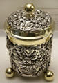 Ornately carved, lidded silver cup on "ball" feet with gold plated trim by goldsmith Adolf Gaap from Augsburg at Maximilian Museum. Augsburg, Germany.