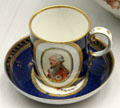 Porcelain coffee cup painted with wigged German in military uniform from Ansbach at Germanisches Nationalmuseum. Nuremberg, Germany.
