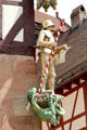 Sculpture of St Michael slaying dragon on corner of building on Tiergärtnertorplatz. Nuremberg, Germany.