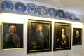 Tucher family portraits under collection of blue ceramic plates at Tucher Mansion Museum. Nuremberg, Germany.